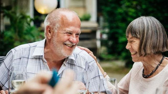Senior couple laughing while eating